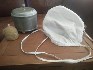 a silver container and a cloth cap